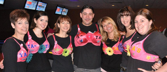 One of our 2012 bowling teams, Team Ta-Tas, shows their support and spirit in matching pink costumes.
